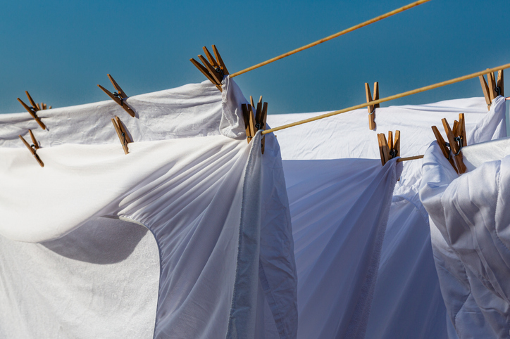 “Lautrer Schatten”- Wäsche auf der Leine, “Lautrer Schatten”- Wäsche auf der Leine White laundry drying on a clothesline in bright sunlight against a clear blue sky, creating a vibrant atmosphere in an outdoor setting during a summer day.